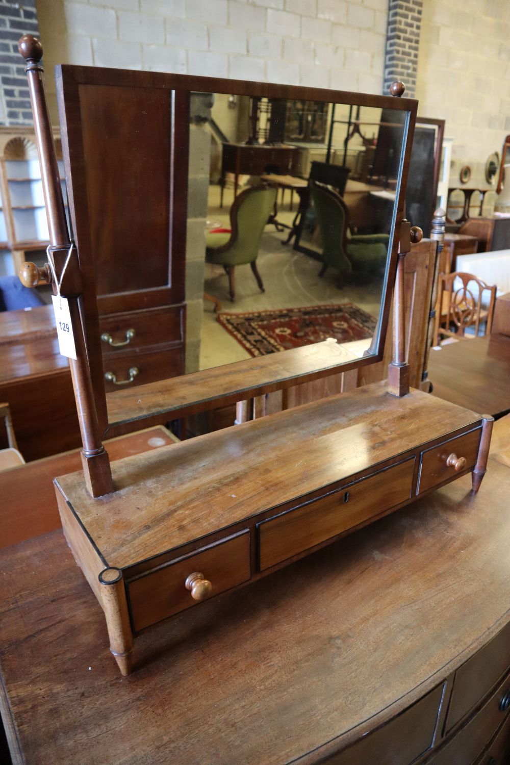 A Regency mahogany five drawer bowfront chest, width 91cm and a mahogany toilet mirror, width 67cm